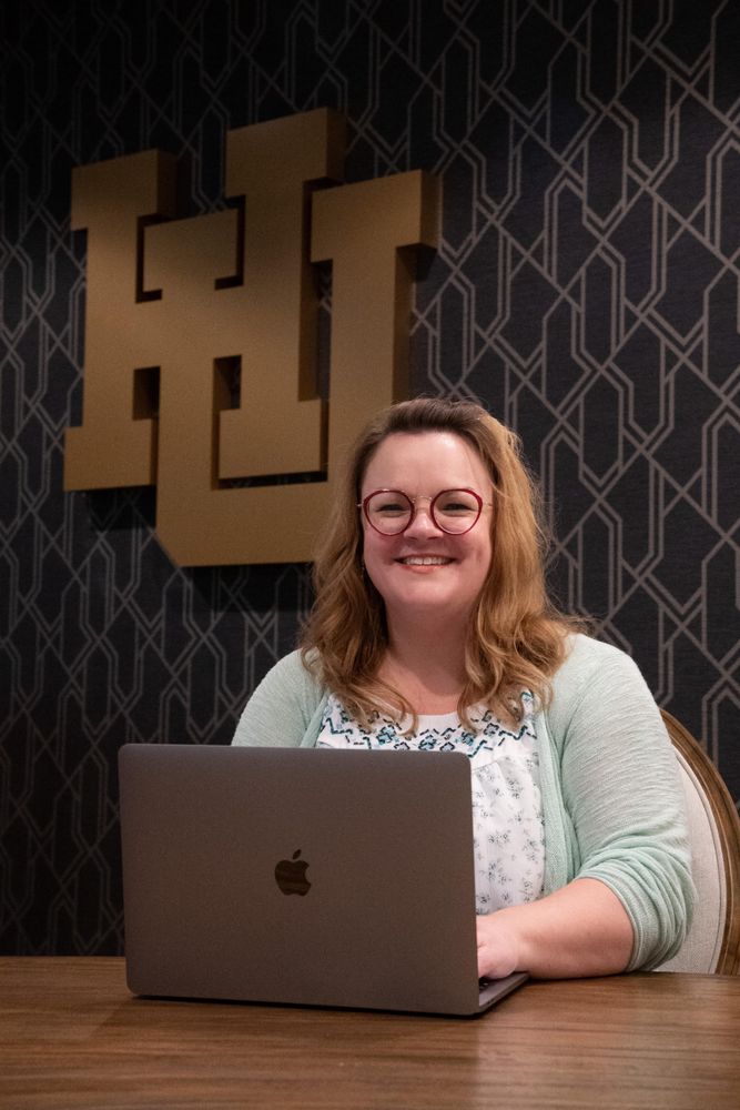 Dr. Andrea Bishop sits behind her computer